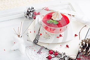 Red fruit Panacotta with green mint leaves photo