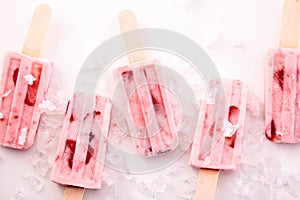 Red Fruit Yogurt Popsicles Chilling on Ice