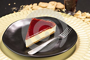 Red fruits Cheesecake frutas on a black plate photo