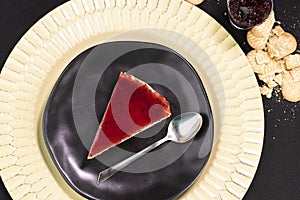 Red fruits Cheesecake frutas on a black plate photo