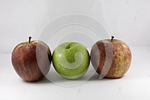 Red fuji apple and green granny smith apple on white background
