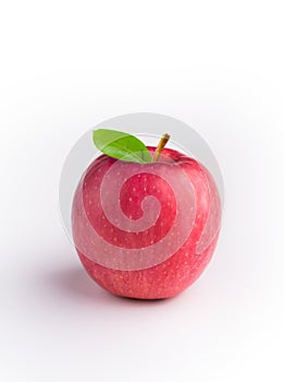 A red Fuji apple with leaves