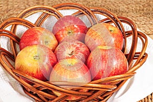 Red Gala apples in a wicker plate