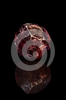 Red garnet gemstone, silicate minerals, black background