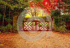 Red gate and autumn colours of beautiful gardens