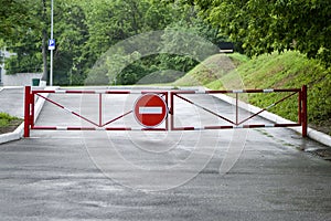 Red gate sign forbidding passage