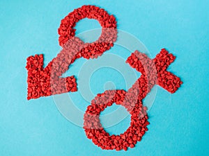 Red gender symbols of small hearts on a blue background. Male and female sign composed of hearts