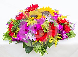 Red Gerbera flowers and Sunflowers on white table