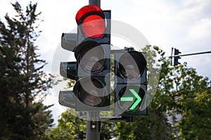 Red german traffic light with green arrow light up allow by law to turn right