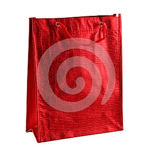 Red gift bag isolated on the white background. It is a big bag with an embossed pattern. It is intended for shopping or for