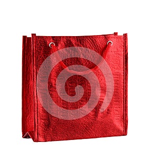 Red gift bag isolated on the white background. It is a small bag with an embossed pattern. It is intended for shopping or for