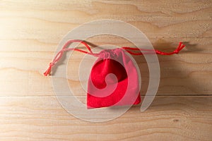 Red Gift Bag on Old Shabby Wooden Table concept Christmas and Newyear.