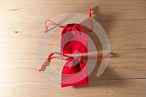 Red Gift Bag on Old Shabby Wooden Table concept Christmas and Newyear.