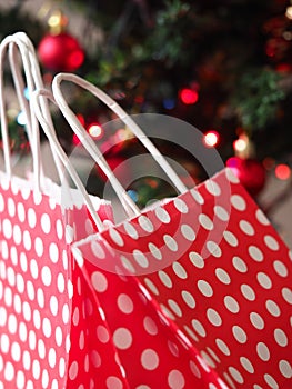 Red gift bags and colorful bokeh background