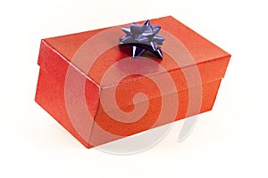 A red gift box with a blue bow, on a white background