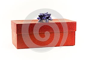 A red gift box with a blue bow, on a white background