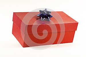 A red gift box with a blue bow, on a white background