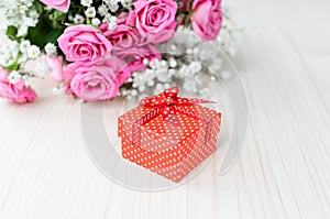 Red gift box and a bouquet. Valentine's Day.