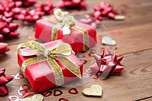 Red gift box with bows, on wooden background. Copy space. Valentine& x27;s day, birthday, Christmas