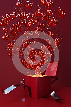 Red gift box with crimson bow opens with an explosion of heart-shaped balloons.