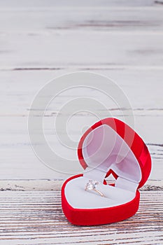 Red gift box with diamond ring.