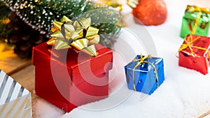 Red gift box with gold ribbon and bow with gift and christmas Decoration New year christmas background
