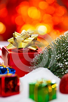 Red gift box with gold ribbon and bow with gift and christmas Decoration New year christmas background