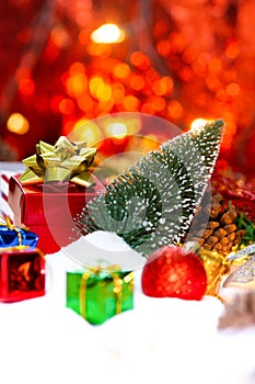 Red gift box with gold ribbon and bow with gift and christmas Decoration New year christmas background