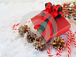 Red gift box and golden pine cone,candy cane on white background. Christmas,New year concept.