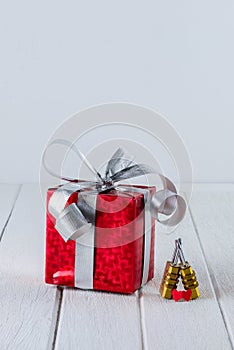 Red gift box with Heart shape and Couple Combination golden padlock on white wooden table