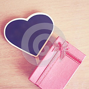 Red gift box and heart shaped blackboard