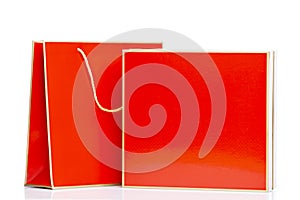 Red gift box with package. Surprises, gifts and congratulations on holidays. Space for text. Isolated on a white background