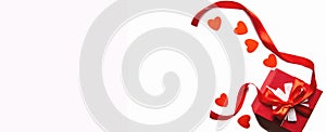 Red gift box with ribbon and hearts on a white background, isolated image