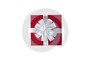 Red gift box with white ribbon and bow isolated on white background top view close up