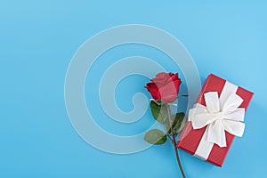 Red gift box with white ribbon bow and rose, concept of Valentine`s day, anniversary, mother`s day, birthday surprise present,