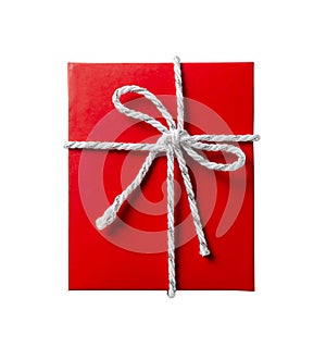 Red gift box with white and silver rope bow isolated on white background