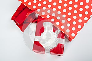 Red gift boxes and and christmas hat in shopping bags