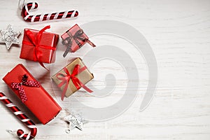 Red gift boxes and decorations on Christmas table background