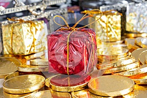 red gift boxes and a gold coin are placed against the background