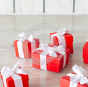 Red gift boxes on white wooden floor