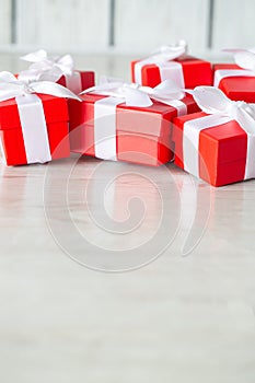 Red gift boxes on white wooden floor