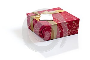 Red gift with gold satin ribbon bow on white background