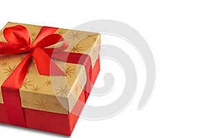 Red gift or present box with golden colored top and red ribbon bow isolated on white background