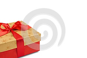 Red gift or present box with golden colored top and red ribbon bow isolated on white background