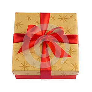 Red gift or present box with golden colored top and red ribbon bow isolated on white background closeup