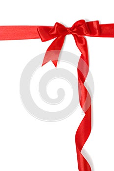 Red gift ribbon and bow isolated over white