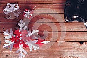 Red gift seasonal with red and white snow flake, round glass, plant, special present for winter holiday on the wooden board