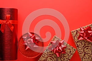 Red gifts on a red background, with space for congratulation. Love day, Valentine`s day, birthday or Christmas