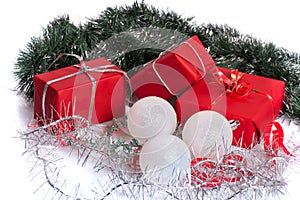 red gifts with silver tinsel and white balls