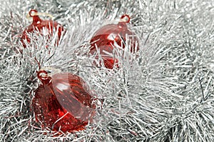 Red glass baubles on silver tinsel.